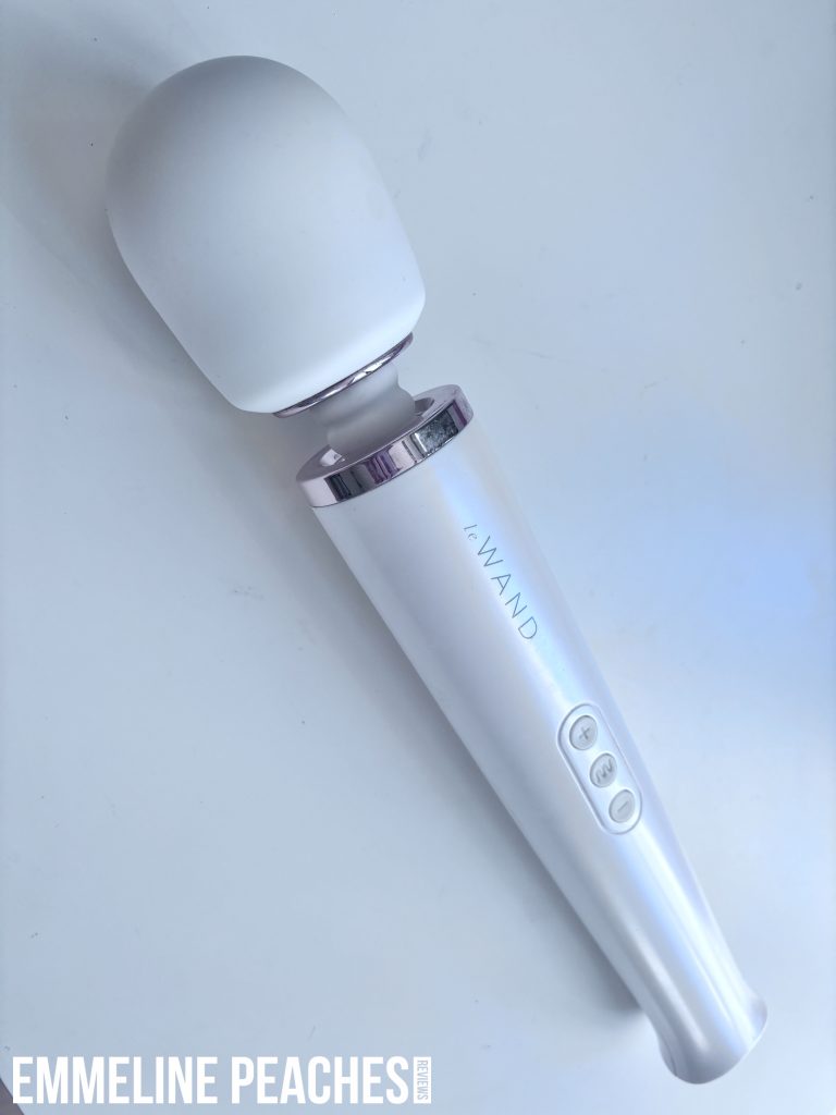 LeWand Vibrator with packaging and accessories on elegant background
